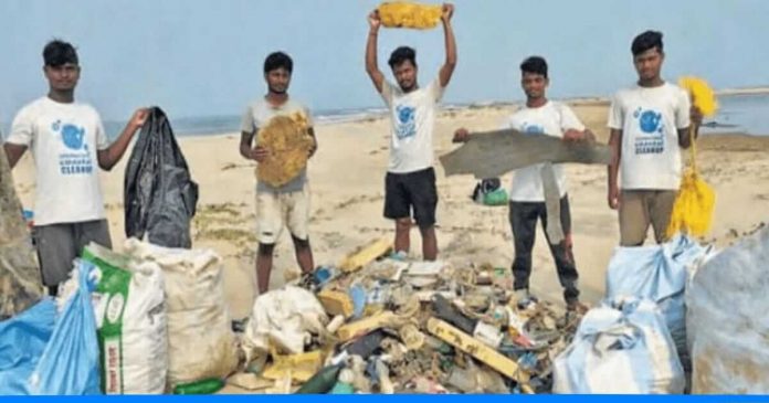 Team of six young boy cleans beach