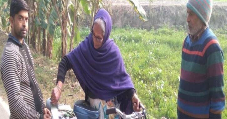 Old lady cycles to sell milk