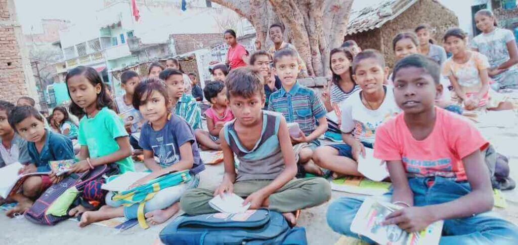 Image of slum children sitting and reading